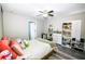 Bright bedroom with ceiling fan, shelving units and a comfortable bed at 4610 Courtland St, Tampa, FL 33610