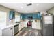 Modern kitchen with stainless steel appliances, ample cabinet space, and stylish gray wood flooring at 4610 Courtland St, Tampa, FL 33610