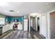 Spacious kitchen with stainless steel appliances, blue and white cabinets, and modern gray flooring at 4610 Courtland St, Tampa, FL 33610