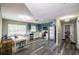 Open-concept kitchen featuring stainless steel appliances, white countertops, and stylish gray flooring at 4610 Courtland St, Tampa, FL 33610