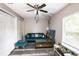 Cozy living room with a comfortable teal sofa and ceiling fan at 4610 Courtland St, Tampa, FL 33610
