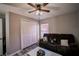 Comfortable living room featuring wood-look flooring, ceiling fan, and a large closet at 4610 Courtland St, Tampa, FL 33610