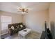 Cozy living room features a plush brown sofa, ceiling fan, and bright natural light at 4610 Courtland St, Tampa, FL 33610