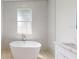 Bathroom features a free-standing tub, a walk-in shower, and marble countertops at 5051 Gevalia Dr, Brooksville, FL 34604