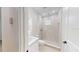 Contemporary bathroom featuring a walk-in shower with pebble floor and bright, backlit mirror over the sink at 5051 Gevalia Dr, Brooksville, FL 34604