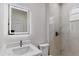 Bathroom featuring modern lighting, a vanity with quartz countertop, and a fully tiled walk-in shower at 5051 Gevalia Dr, Brooksville, FL 34604