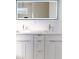 Bathroom vanity with double sinks and a lighted mirror at 5051 Gevalia Dr, Brooksville, FL 34604