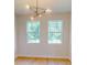 Dining room featuring modern lighting fixture and large windows with outside views at 5051 Gevalia Dr, Brooksville, FL 34604