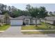 New construction featuring a modern exterior, spacious driveway, and landscaped front yard ready for customization at 5051 Gevalia Dr, Brooksville, FL 34604