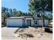 Construction in progress with a modern home exterior, driveway, and landscaping awaiting finishing touches at 5051 Gevalia Dr, Brooksville, FL 34604