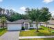 Beautiful one-story home with manicured lawn, paved driveway, and inviting front entrance with modern appeal at 5051 Gevalia Dr, Brooksville, FL 34604