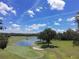 Scenic view of the golf course featuring a tranquil lake and lush green fairways at 5051 Gevalia Dr, Brooksville, FL 34604