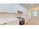 Modern kitchen with stainless steel oven, quartz countertops and sleek range hood at 5051 Gevalia Dr, Brooksville, FL 34604