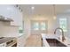 Gourmet kitchen with island sink, gold fixtures, stainless oven and adjacent dining area at 5051 Gevalia Dr, Brooksville, FL 34604