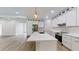 Modern kitchen featuring stainless steel appliances, granite countertops, a large island, and ample cabinet space at 5051 Gevalia Dr, Brooksville, FL 34604