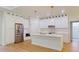 Modern kitchen with stainless steel appliances, white cabinetry, and a center island at 5051 Gevalia Dr, Brooksville, FL 34604