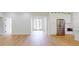 Open-concept living area with hardwood floors, white walls, and modern kitchen features at 5051 Gevalia Dr, Brooksville, FL 34604