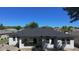 The rear of the house has a patio area, perfect for outdoor entertaining, with several windows and a modern roof at 5051 Gevalia Dr, Brooksville, FL 34604