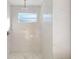 Shower with rain shower head and marble tiling at 5051 Gevalia Dr, Brooksville, FL 34604