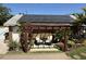 Inviting backyard sitting area featuring a pergola, lush greenery, and solar panels on the roof at 5201 18Th S Ave, Gulfport, FL 33707