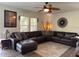 Spacious living room with a large sectional sofa, ceiling fan and stylish decor at 5201 18Th S Ave, Gulfport, FL 33707