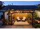 Cozy backyard with stone patio, pergola, and lush plants creating a serene retreat at 5201 18Th S Ave, Gulfport, FL 33707