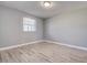 Minimalist bedroom featuring hardwood floors, a window, and neutral-colored walls at 525 9Th N Ave # 2, St Petersburg, FL 33701