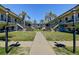 A well-maintained courtyard featuring lush green grass, palm trees, and a central walkway at 525 9Th N Ave # 2, St Petersburg, FL 33701