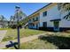 Inviting courtyard view of a two-story apartment building with manicured lawn, walkway, and neatly trimmed bushes at 525 9Th N Ave # 2, St Petersburg, FL 33701