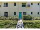 Charming exterior of building with a teal door, and professionally landscaped surroundings at 525 9Th N Ave # 2, St Petersburg, FL 33701