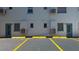 Exterior view of apartment building featuring parking spaces and air conditioning units, with unit doors labeled at 525 9Th N Ave # 2, St Petersburg, FL 33701