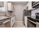 Modern kitchen featuring stainless steel appliances and bright white cabinetry at 525 9Th N Ave # 2, St Petersburg, FL 33701
