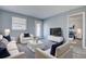 Bright living room with a glass coffee table, plush seating, and light gray wood flooring at 525 9Th N Ave # 2, St Petersburg, FL 33701