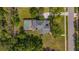 A luxurious residence seen from above, featuring a beautiful pool area, lush landscaping, and a meticulously maintained lawn at 5913 Flatwoods Manor Cir, Lithia, FL 33547