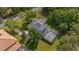 Aerial view shows pool area surrounded by mature trees, landscaped yard, and screened enclosure at 5913 Flatwoods Manor Cir, Lithia, FL 33547