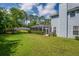 Spacious backyard featuring a screened-in patio area and a well-manicured lawn at 5913 Flatwoods Manor Cir, Lithia, FL 33547