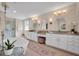 A luxurious bathroom boasts a soaking tub, double vanity, and elegant lighting at 5913 Flatwoods Manor Cir, Lithia, FL 33547