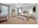Comfortable bedroom with carpet, large windows, and a neutral color scheme at 5913 Flatwoods Manor Cir, Lithia, FL 33547
