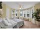 Sunny bedroom with multiple windows, a desk, and a ceiling fan at 5913 Flatwoods Manor Cir, Lithia, FL 33547