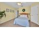 Cozy bedroom with soft lighting, carpeted floor, and a comfortable bed at 5913 Flatwoods Manor Cir, Lithia, FL 33547