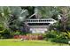 Elegant community sign for Fish Hawk Trails surrounded by lush tropical landscaping at 5913 Flatwoods Manor Cir, Lithia, FL 33547