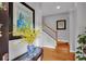 A welcoming foyer with hardwood floors, a staircase, and a decorative floral arrangement at 5913 Flatwoods Manor Cir, Lithia, FL 33547