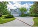 Home exterior with a driveway, garage, and landscaping at 5913 Flatwoods Manor Cir, Lithia, FL 33547
