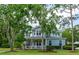 Charming two-story home with inviting front porch and beautifully landscaped front yard at 5913 Flatwoods Manor Cir, Lithia, FL 33547