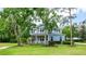 Charming two-story home with inviting front porch and beautifully landscaped front yard at 5913 Flatwoods Manor Cir, Lithia, FL 33547