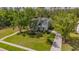 Charming two-story home with a welcoming front porch and mature trees on a lush green lawn at 5913 Flatwoods Manor Cir, Lithia, FL 33547