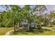 Charming two-story home with a welcoming front porch and mature trees on a lush green lawn at 5913 Flatwoods Manor Cir, Lithia, FL 33547
