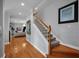 Spacious hallway with hardwood floors, staircase, and seamless connection to living areas at 5913 Flatwoods Manor Cir, Lithia, FL 33547