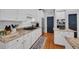 Modern kitchen with stainless steel appliances, granite countertops, and white cabinetry at 5913 Flatwoods Manor Cir, Lithia, FL 33547