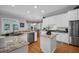 Kitchen with stainless steel appliances, granite counters, and island at 5913 Flatwoods Manor Cir, Lithia, FL 33547